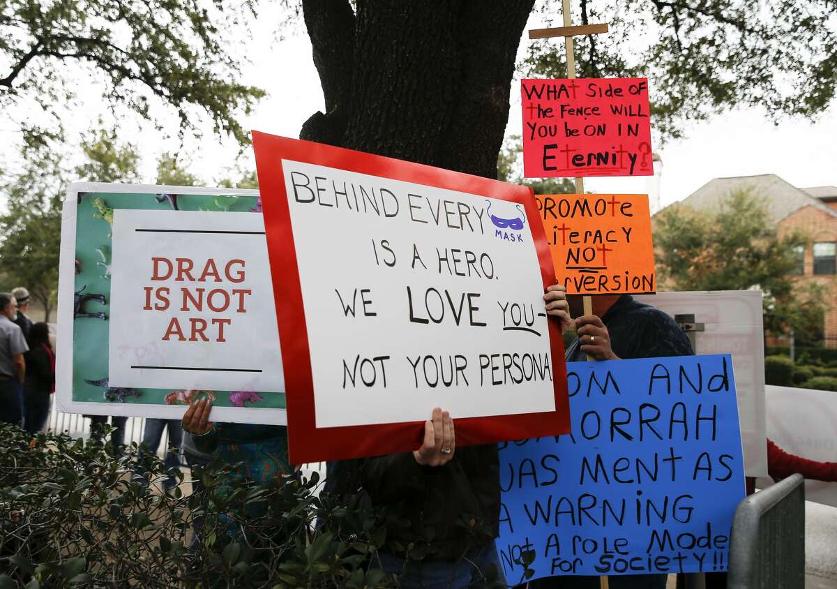 Drag Queen Storytime protesters gather outside of the Freed-Montrose Neighborhood Library to against drag queens reading stories to children on Saturday, Jan. 26, 2019, in Houston. Drag Queen Storytime supporters gathered across a driveway from the protesters. The library just increaded the monthly Drag Queen Storytime event from one session to two sessions due to the popularity.