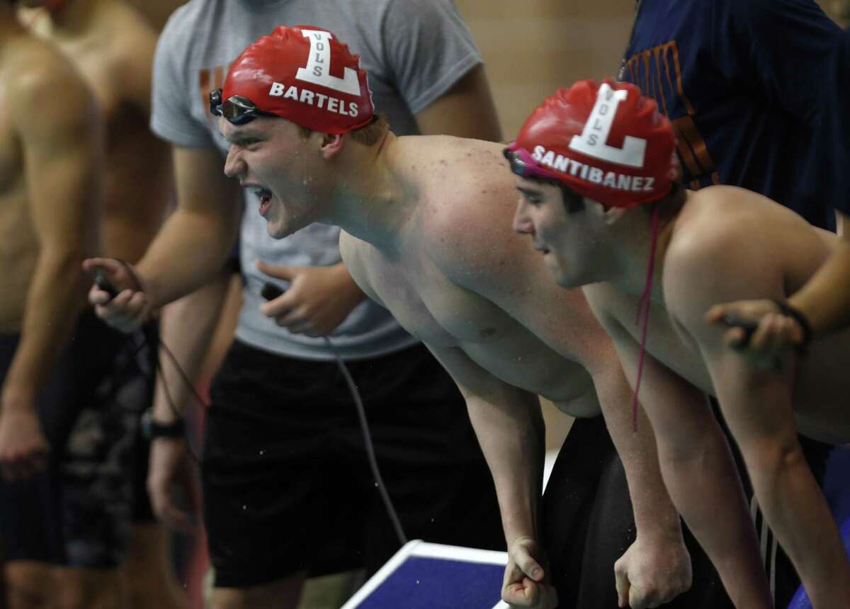Lee's Lyle Bartels cheers on his teammates in their winning performance in 200 yard Relay on his left is teammate Marcelo Santibanez from the District 25-6A swimming championships at Davis Natatorium on Saturday, January 2, 2019