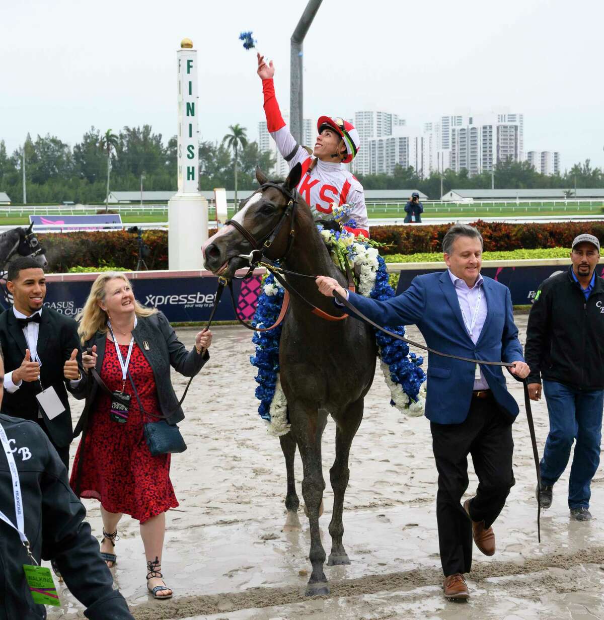 Bricks and Mortar ridden by Irad Ortiz Jr. is led to the winner's circle by co-owner Bill Lawrence, right, after winning the 1st. running of The Pegasus World Cup Turf International at Gulfstream Park Jan. 26, 2019 in Hallandale Beach, Florida. Photo Special to the Times Union by Skip Dickstein