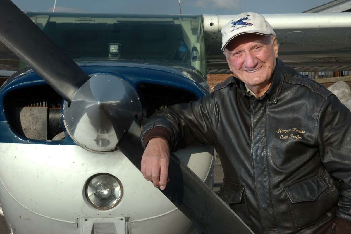 Morgan Kaolian poses next to one of his airplanes at Sikorsky Memorial Airport in Stratford on Jan. 6, 2011.