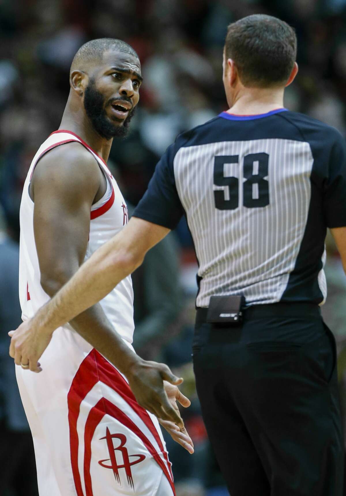 Houston Rockets guard Chris Paul (3) talks to referee Josh Tiven (58) during a time out in the second half of an NBA basketball game against the Orlando Magic at Toyota Center on Sunday, Jan. 27, 2019, in Houston.
