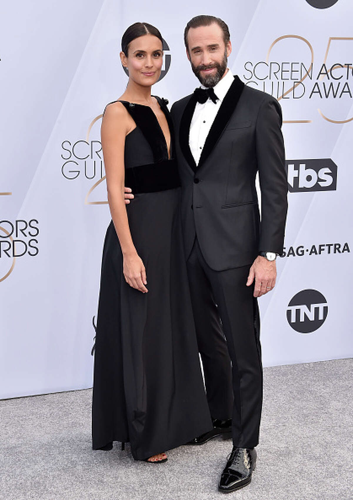 LOS ANGELES, CA - JANUARY 27: Maria Dolores Dieguez (L) and Joseph Fiennes attend the 25th Annual Screen Actors Guild Awards at The Shrine Auditorium on January 27, 2019 in Los Angeles, California. (Photo by Axelle/Bauer-Griffin/FilmMagic)