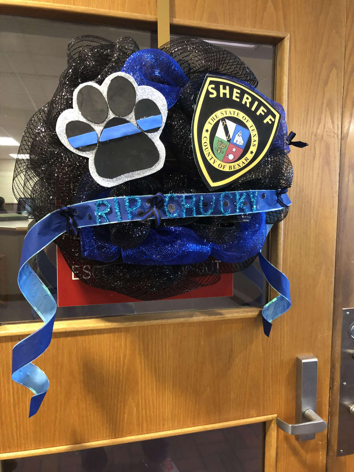 A memorial wreath for Bexar County K9 Chucky hangs at the Bexar County Sheriff's Office on Monday, Jan. 28, 2019.