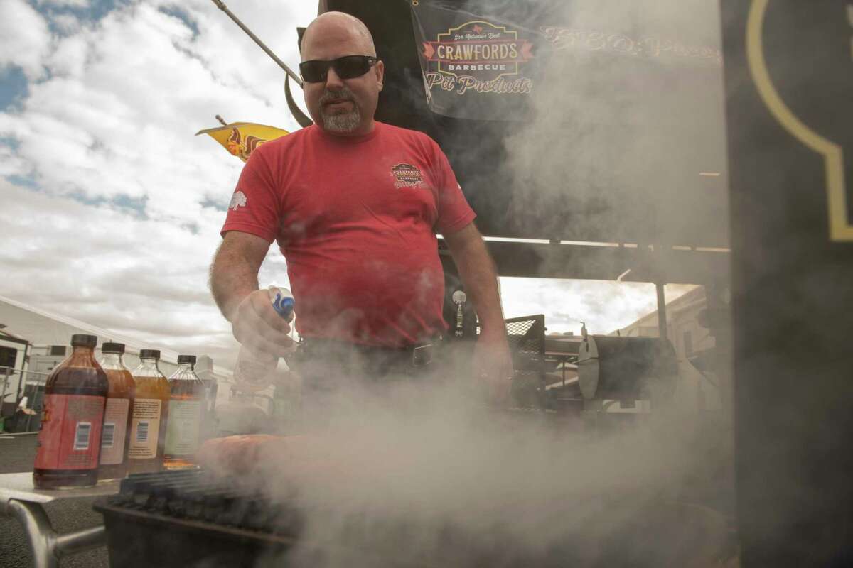 Bryan Crawford applies spritzers of his own creation during the San Antonio Stock Show & Rodeo Bar-B-Que Cook-Off competition. Crawford started his own company, Crawford’s Barbecue, and also sells dry rubs and sauces.