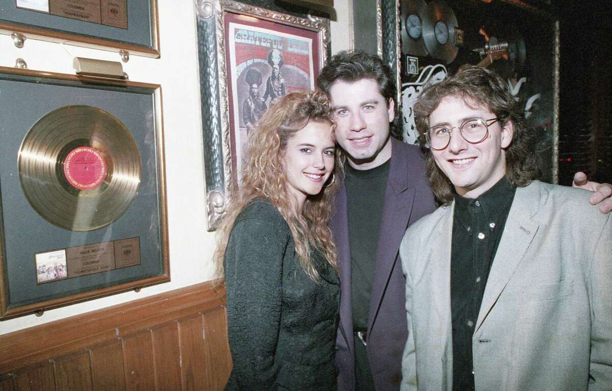 Kelly Preston, left, John Travolta and Arye Gross at the Hard Rock Cafe on Jan. 12, 1989, to promote the film "The Experts."