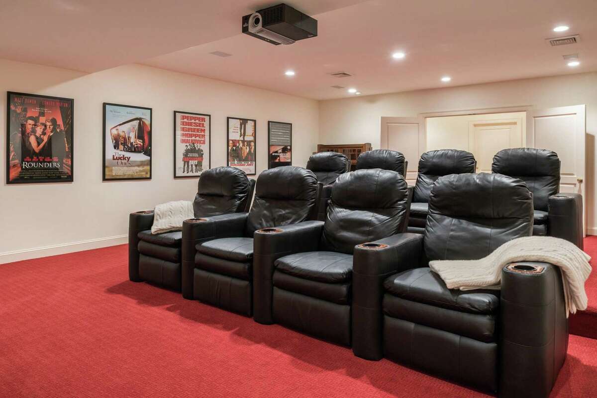 The home theater is just one of the many amenities at 7 Wyckham Hill Lane, a mid-country estate with a nearly 14,000 square foot Georgian colonial, lakefront dock, pool and spa, and tennis court. Coldwell Banker Residential Brokerage has the property listed for $6.95 million.