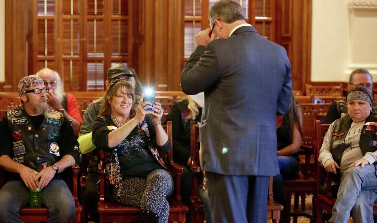 Rep. Reggie Smith of Grayson County reads a letter given to him by a group of biker from his district as one of them takes his picture. Bikers from around the state converged on the Texas Capitol to protest a bill that would require helmets for all riders, on Monday, Jan. 28, 2019.