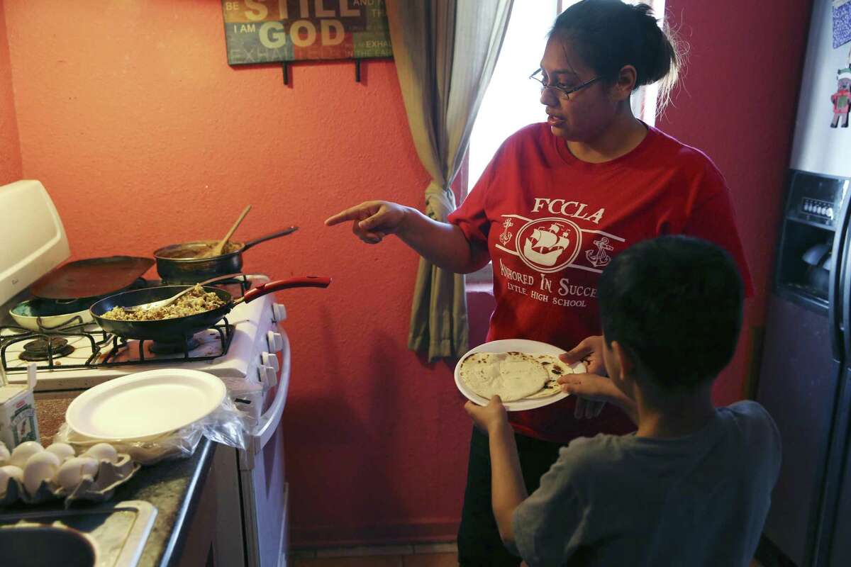 Crystal Guevara-Alvarado, 30, serves breakfast tacos to her son, Ishmael Alvarado, 8. Guevara-Alvarado grew up in foster care and is determined to make her own children’s lives happier. She quit her job at an immigration detention center because it was putting too much stress on herself and her kids. Even with the job, she fell within the ALICE threshold — making less than what it takes to pay for basic necessities in San Antonio.