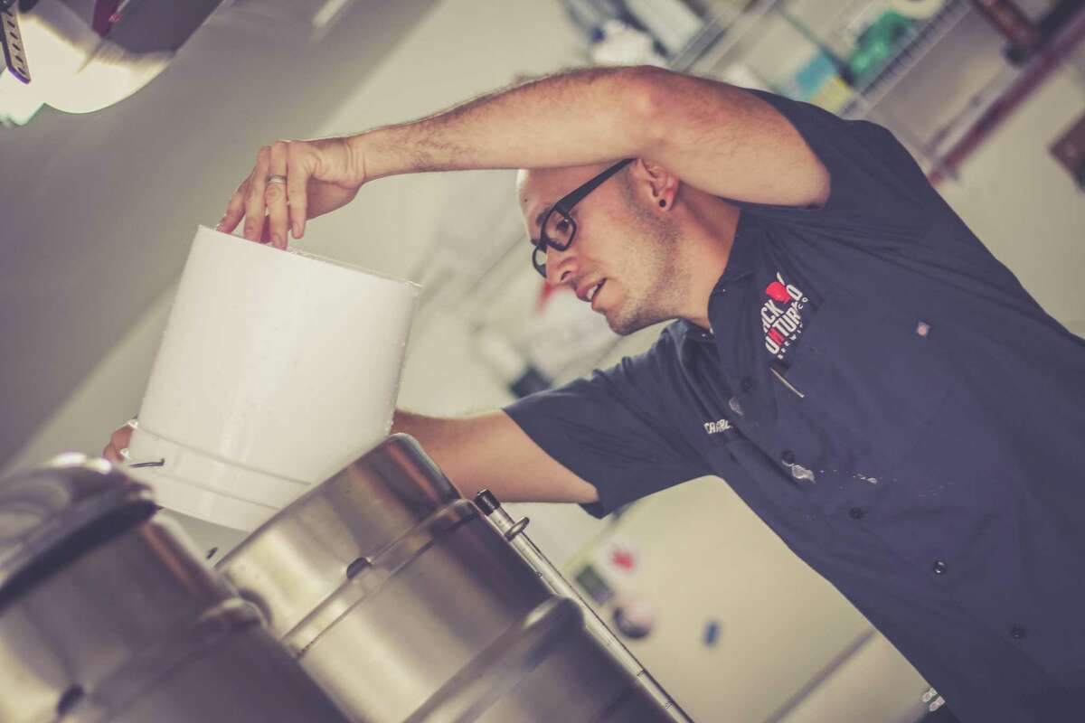 Back Unturned Brewing Co. owner and brewmaster Ricardo Garcia prepares a batch of beer. Garcia has been brewing beer for eight years.