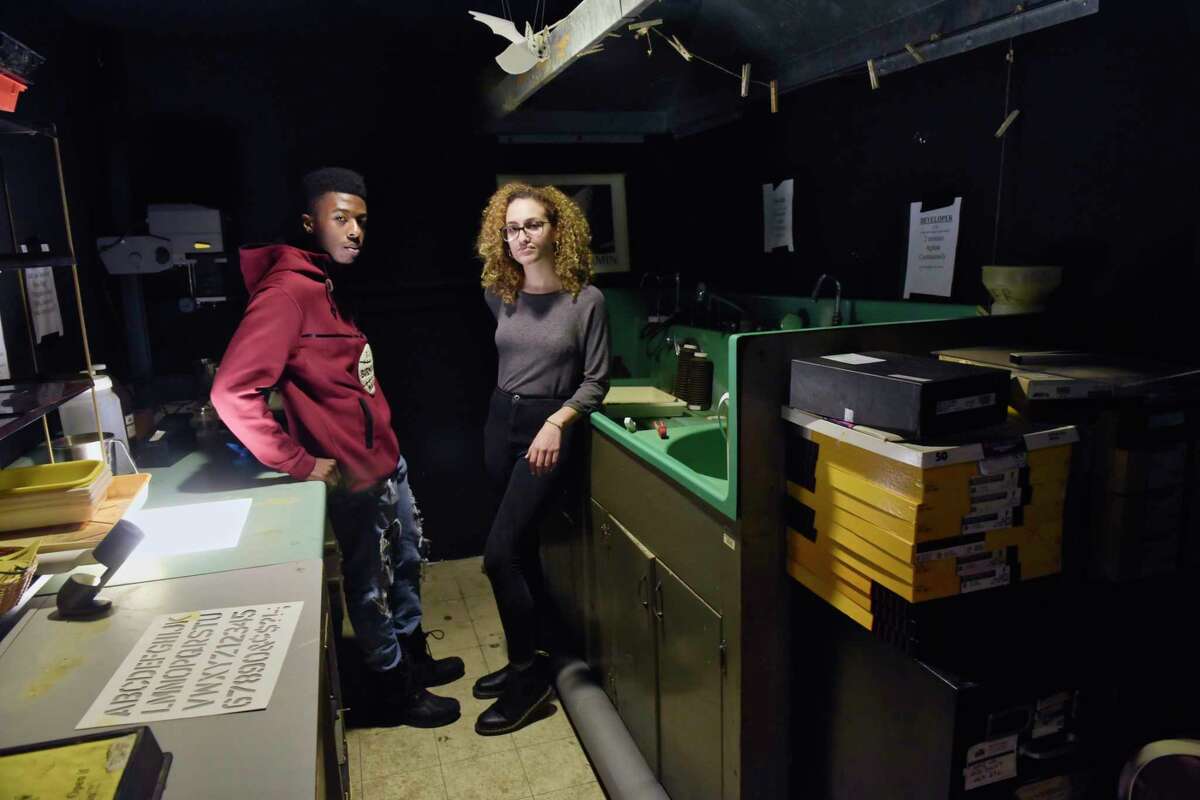 Jarron Childs, left, the vice president of the University Photo Service student organization, and Sabrina Flores, president of the student organization, pose inside the darkroom on the third floor of the Student Center at the University at Albany on Tuesday, Jan. 29, 2019, in Albany, N.Y. In the late 60's, students in the organization built the darkroom. The University at Albany administration wants to move the student organization out of their photo studio and photo darkroom location and into a much smaller space. (Paul Buckowski/Times Union)