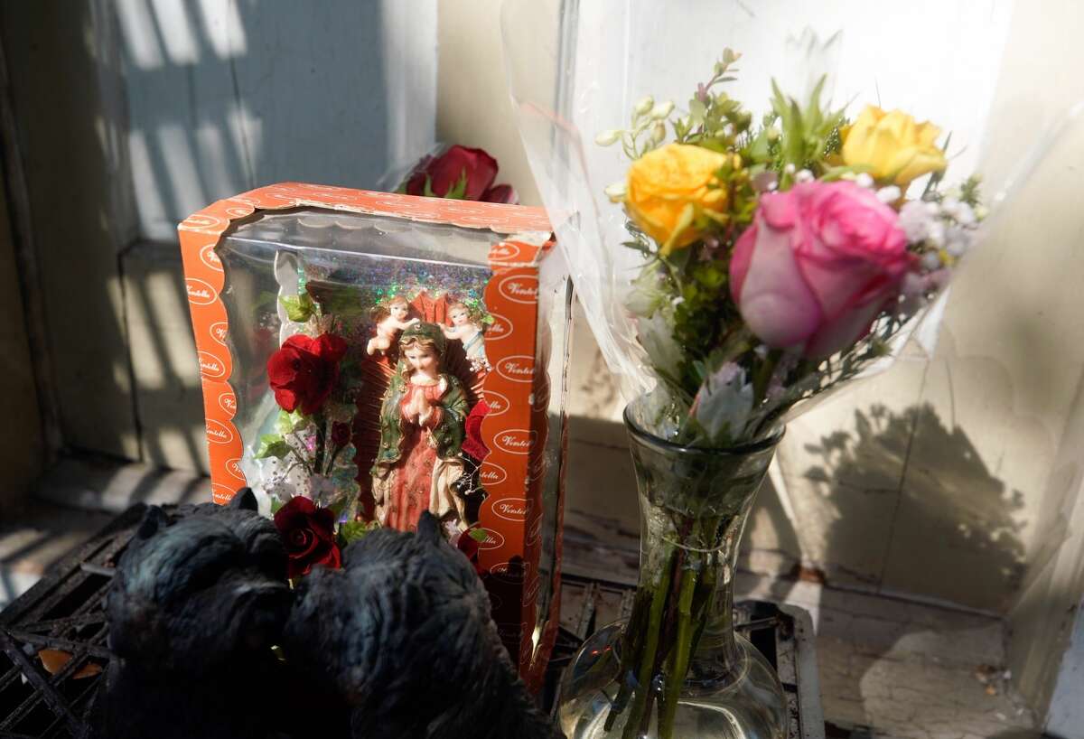A small memorial of statues and flowers are shown at the front door of home at 7815 Harding Tuesday, Jan. 29, 2019 where five Houston Police Officers were shot in a gun battle while serving a search warrant on Monday. Police identified the two suspects who died as Rhogena Nicholas, 58, and Dennis Tuttle, 59.