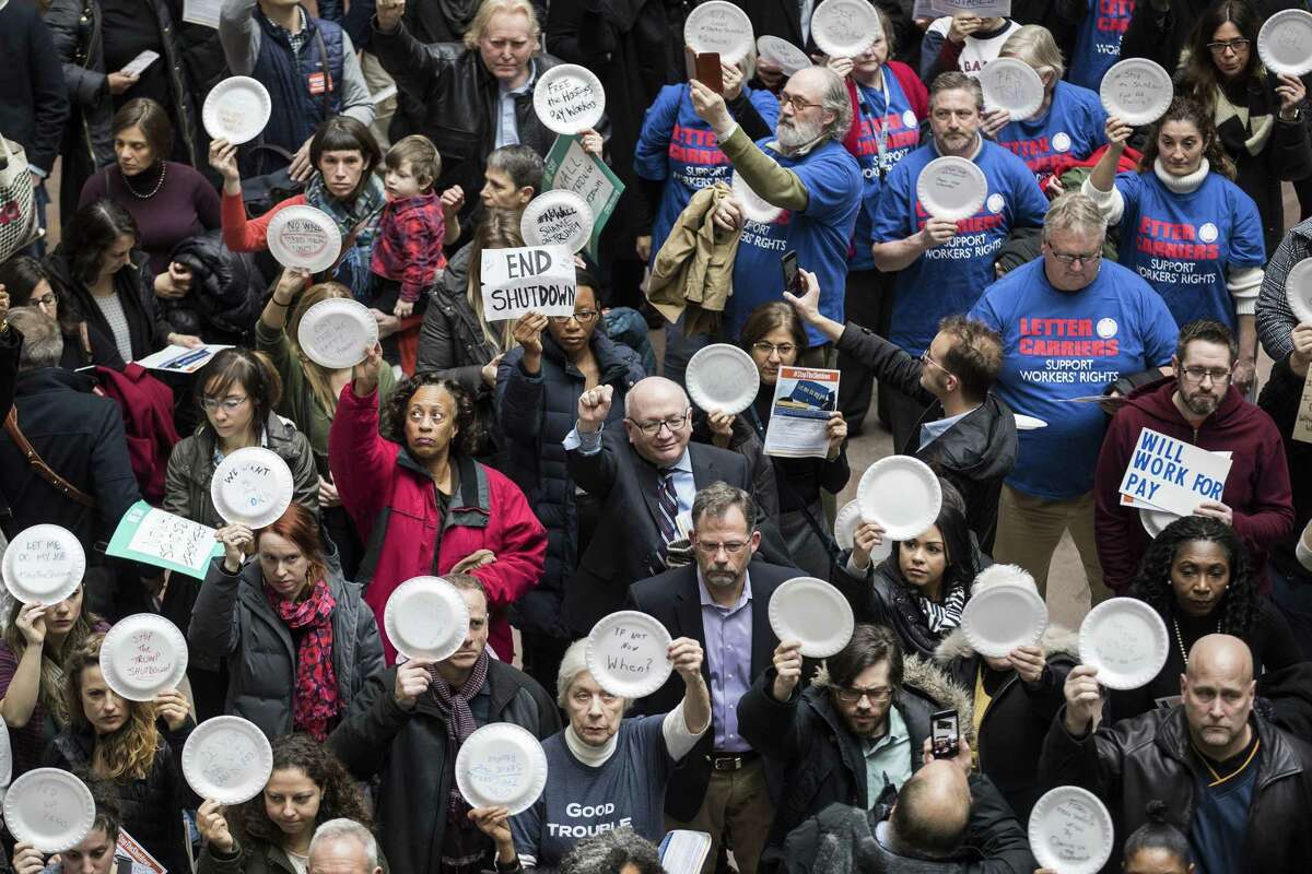 Demonstrators gather in the Hart Senate Office Building atrium to protest the government shutdown, in Washington, Jan. 23, 2019. Before it ended on Friday with a deal between the Trump administration and congressional leaders, the partial shuttering of the government had reordered American life. (Sarah Silbiger/The New York Times)