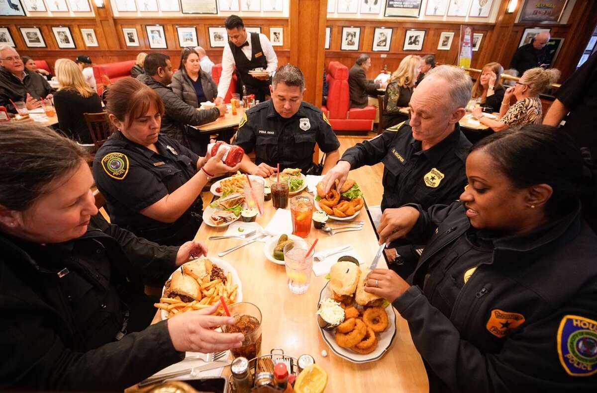 Houston Police from the Midwest Division Officer G. Durrill, left, Officer M. Lugo, Sr. Officer A. Pena, center, Sgt. D. Hopper, and Lt. K.L. Carey, right, eat lunch at Kenny & Ziggy’s New York Delicatessen, 2327 Post Oak, Tuesday, Jan. 29, 2019 in Houston. In the wake of the shooting of five police officers in southeast Houston on Monday, the restaurant offered free meals on Tuesday in appreciation to all the officers of the Houston Police Department.