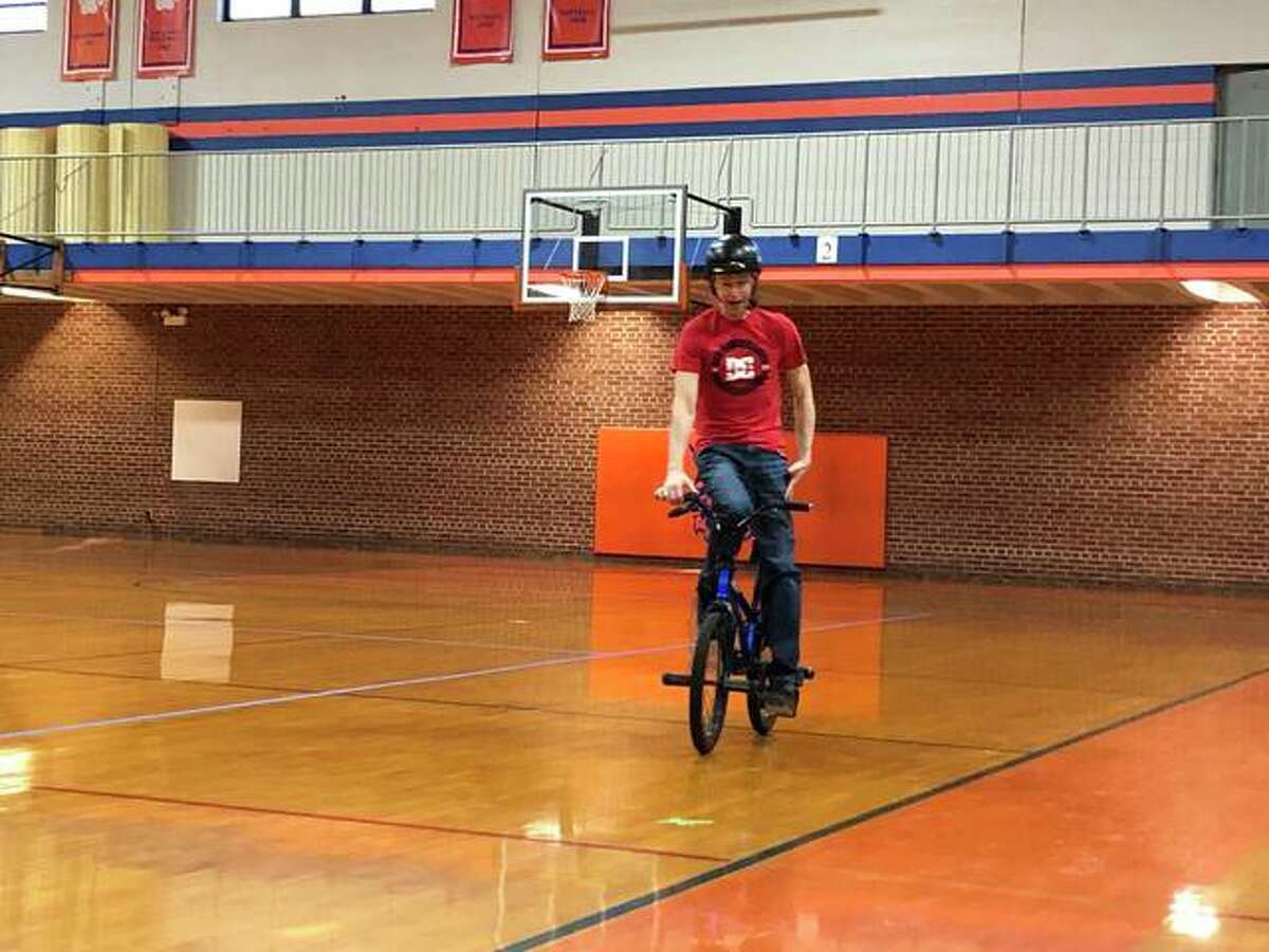 Matt Wilhelm, a three-time X Games medalist, performs tricks for Lincoln Middle School students before speaking to them about his experiences being bullied and how to combat the behavior.