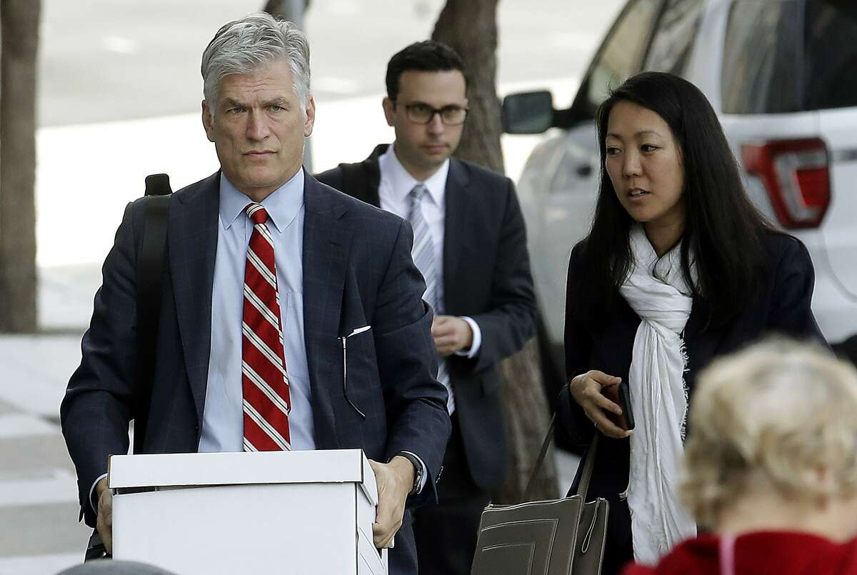 Attorneys Tobias Keller, left, and Jane Kim, representing Pacific Gas & Electric Corp., arrive at a Federal Courthouse in San Francisco, Tuesday, Jan. 29, 2019. Faced with potentially ruinous lawsuits over California's recent wildfires, Pacific Gas & Electric Corp. filed for bankruptcy protection Tuesday in a move that could lead to higher bills for customers of the nation's biggest utility and reduce the size of any payouts to fire victims. (AP Photo/Jeff Chiu)