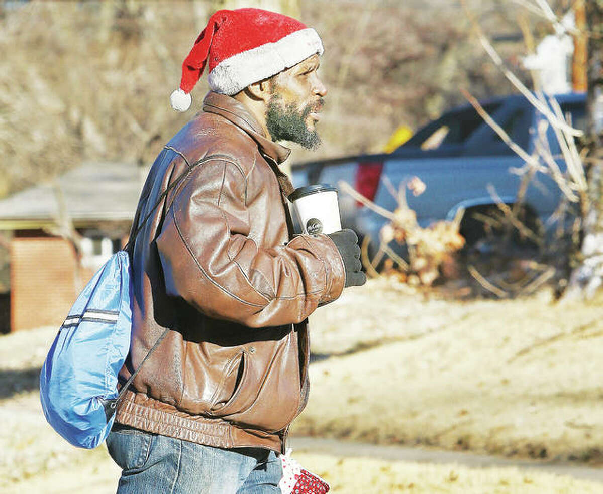 While many people were staying in Tuesday morning, at least one man was braving the cold with a cup of hot coffee and a Santa Claus hat as he walked up Washington Avenue in Alton. Many area schools called off this morning as a “polar vortex” was to bring morning wind chills of 15 to 30 degrees below zero.
