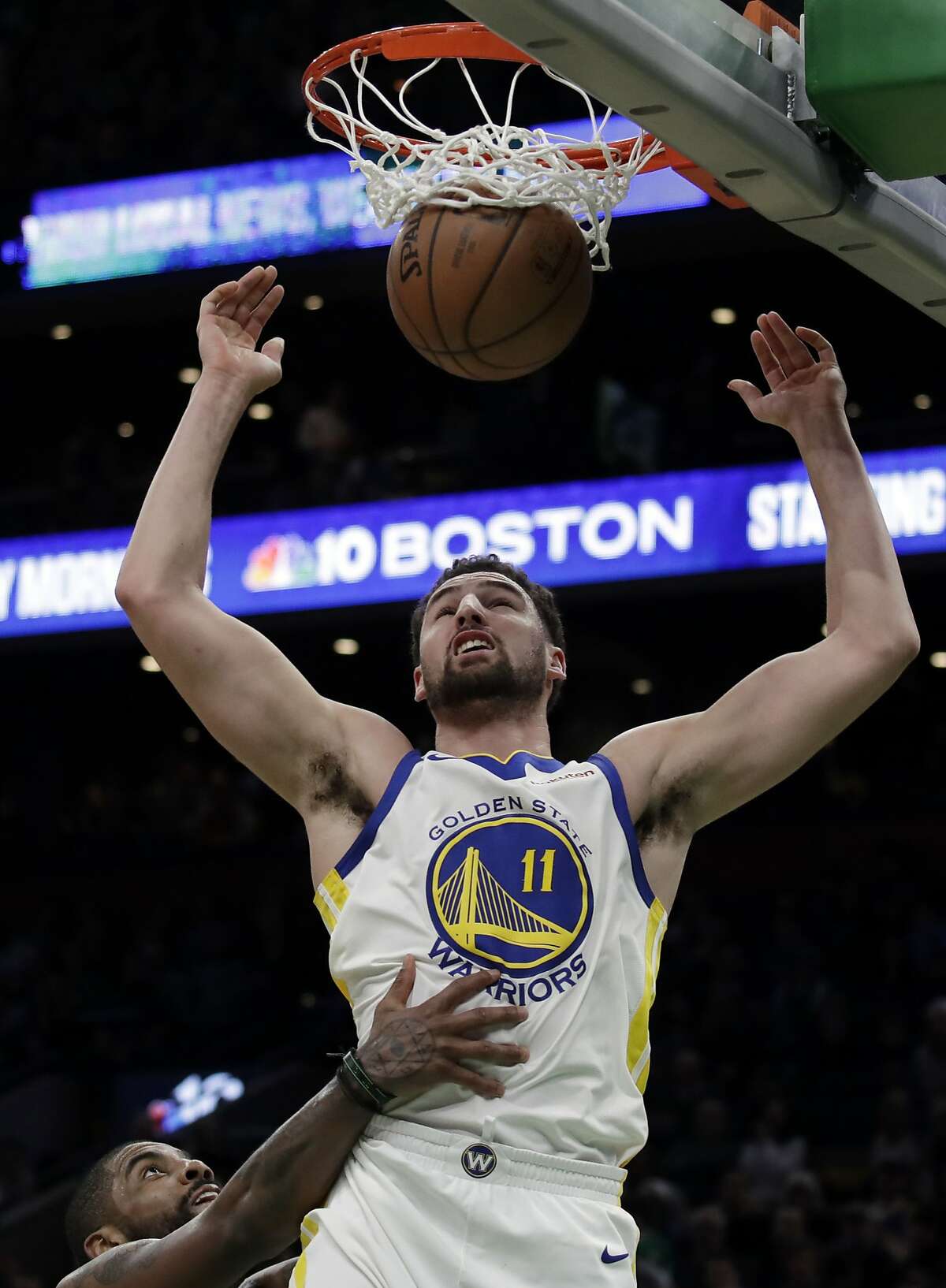 Golden State Warriors guard Klay Thompson (11) dunks against Boston Celtics guard Kyrie Irving, below, in the second half of an NBA basketball game, Saturday, Jan. 26, 2019, in Boston. (AP Photo/Elise Amendola)