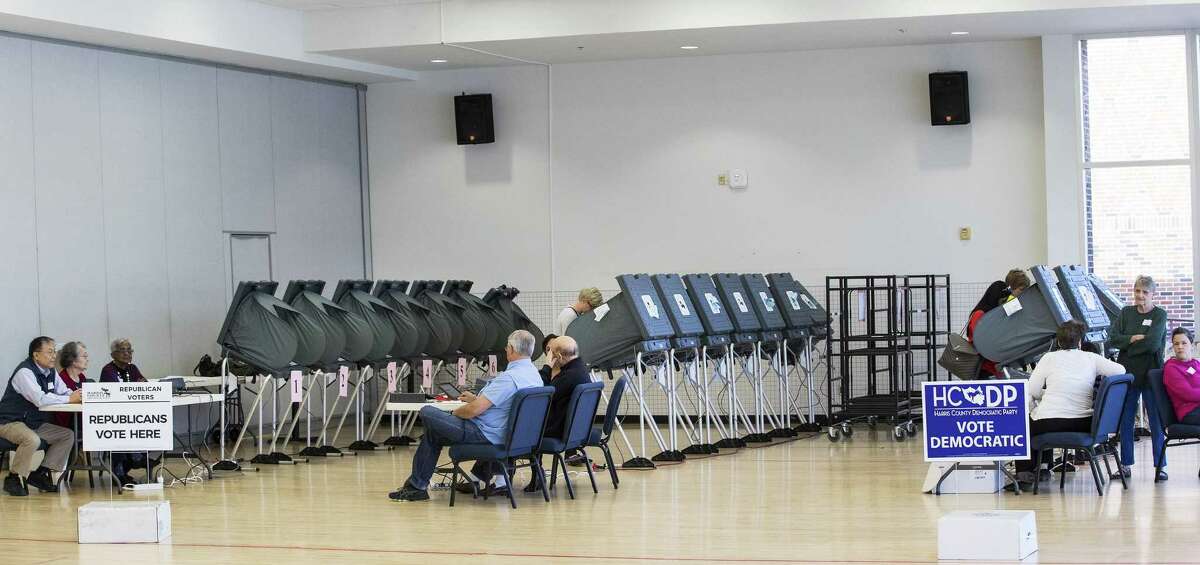 Voters take to the polls in the primaries in March. The ACLU and other groups slammed Texas elections officials who say they found 95,000 people identified as non-citizens who had a matching voter registration record. Texas Attorney General Ken Paxton now says many of them could have become citizens and voted legally. (Brett Coomer/Houston Chronicle via AP, File)