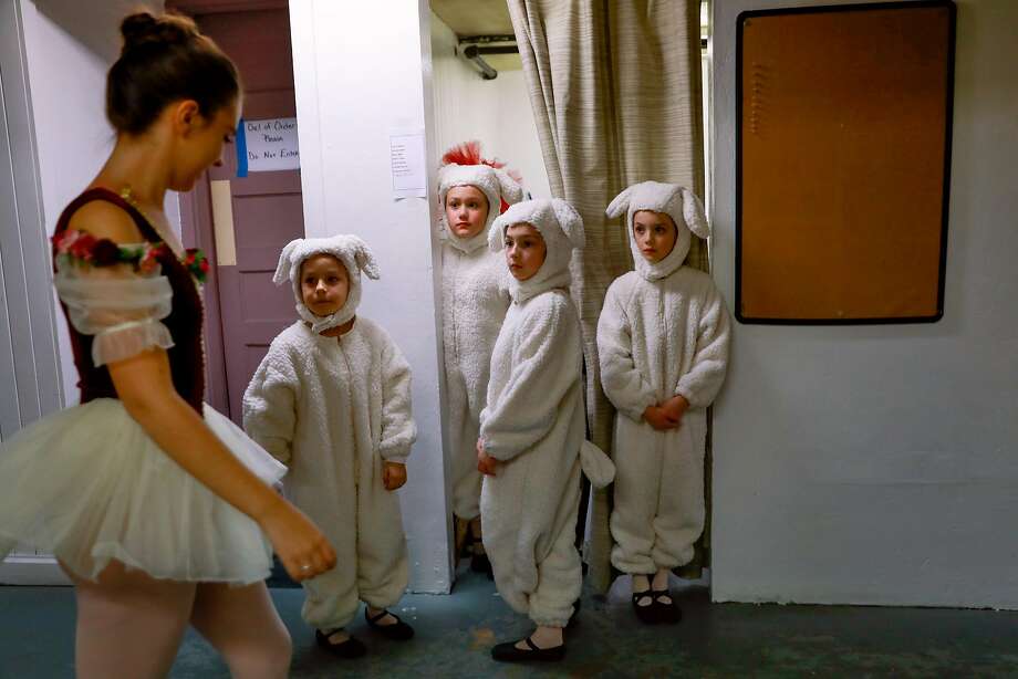 (l-r) Grace Rosendin (left) walks by Andrea Dwelle, 8, Caitlin Tooker, 9 Cordelia Barnett, 8, and Evelyn Spague, 9, who are dressed as sheep backstage during a rehearsal for the Nutcracker at the State Street Theater in Oroville, California, on Tuesday, Jan. 15, 2019.  Grace was one of many dancers who lost their home in Paradise during the Camp Fire. Photo: Photos By Gabrielle Lurie / The Chronicle