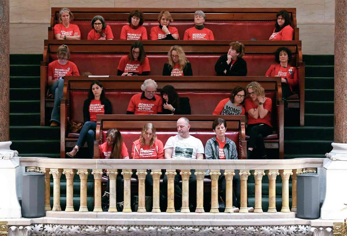 Spectators from the group Moms Demand Action watch as Senators debate new legislation reforms to protect New Yorkers from gun violence in the Senate Chamber at the state Capitol on Tuesday, Jan. 29, 2019, in Albany, N.Y.