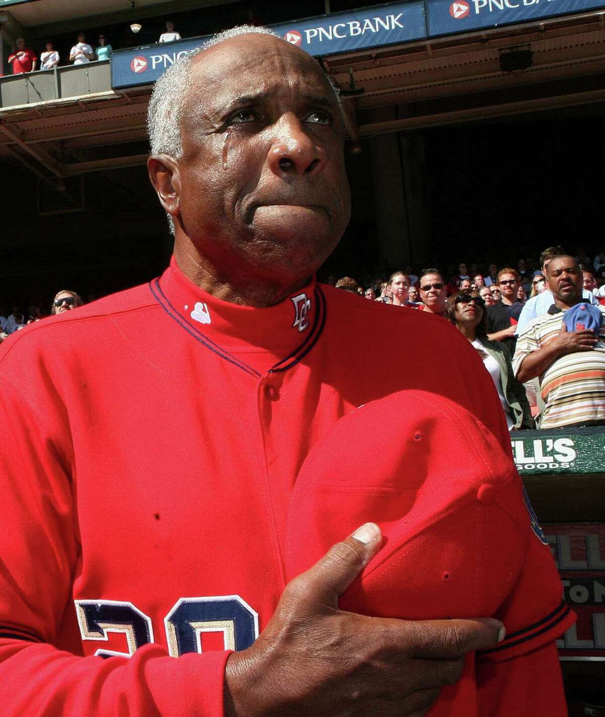 A tear rolls down the cheek of Washington Nationals Manager Frank Robinson as he listens to the national anthem on his last day as the Nationals manager in Washington, October 1, 2006. Robinson, a 71-year-old Hall of Famer, has not been asked to return to the Nationals for next year's season. REUTERS/Joshua Roberts (UNITED STATES) Ran on: 10-02-2006 Frank Robinson, left, shows emotion on his last day as manager of the Nationals; Dusty and Darren Baker enjoy their Cubs uniforms. Ran on: 10-02-2006 Frank Robinson, left, shows emotion on his last day as manager of the Nationals. Dusty and Darren Baker enjoy their Cubs uniforms.