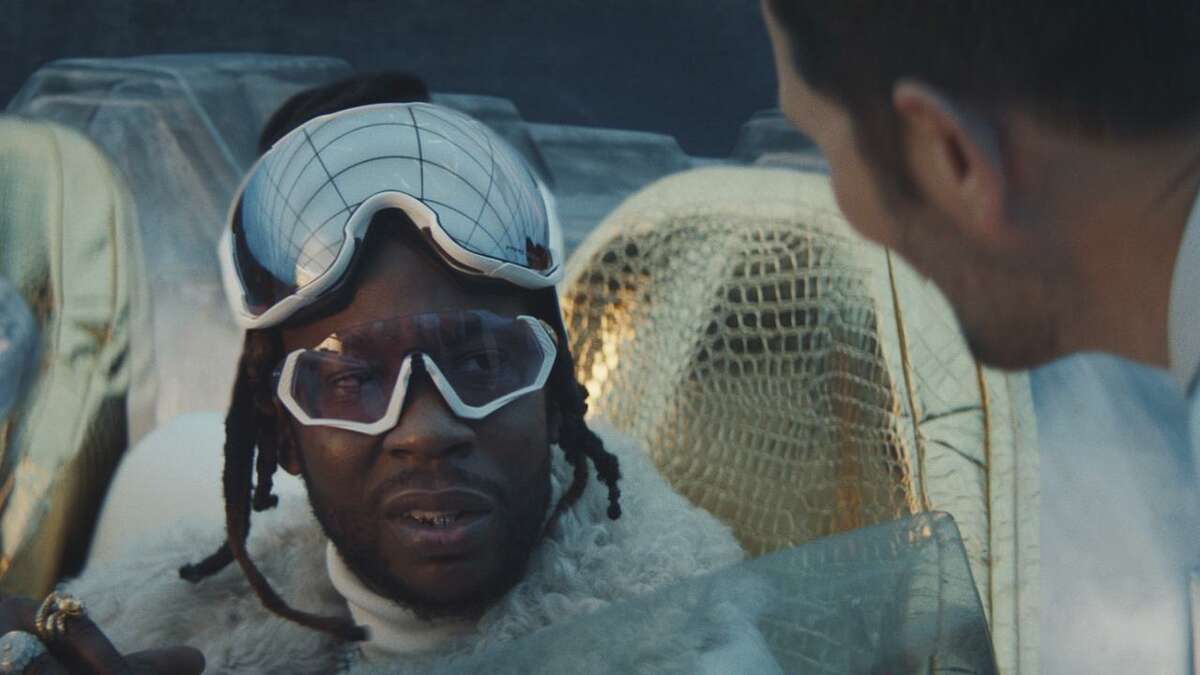This image provided by Expensify shows an image from the company's 2019 Super Bowl NFL football spot featuring 2 Chainz, left, and Adam Scott. First time-Super Bowl advertiser Expensify created a surprisingly catchy music video with rapper 2 Chainz and actor Adam Scott. The 30-second ad also features the song. (Expensify via AP)
