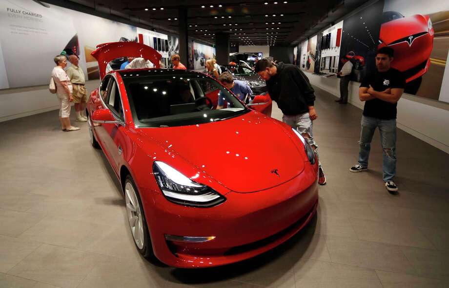Tesla Posts Small 4q Profit Expects To Make Money This Year File In This July 6 2018 Photo Prospective Customers Confer With S