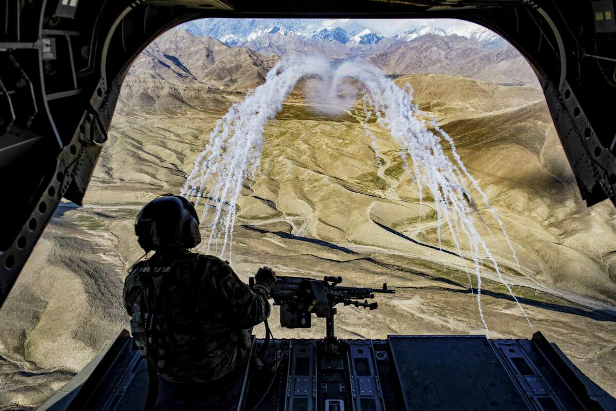 A U.S. Army crew chief observes a flare test during a training flight in Afghanistan, March 14. A hasty American withdrawal from Afghanistan, experts said, would erode the authority and legitimacy of the Afghan government, raising the risk that the Taliban could recapture control. Seventeen years of fighting there, and the question remains whether those circumstances will ever change.