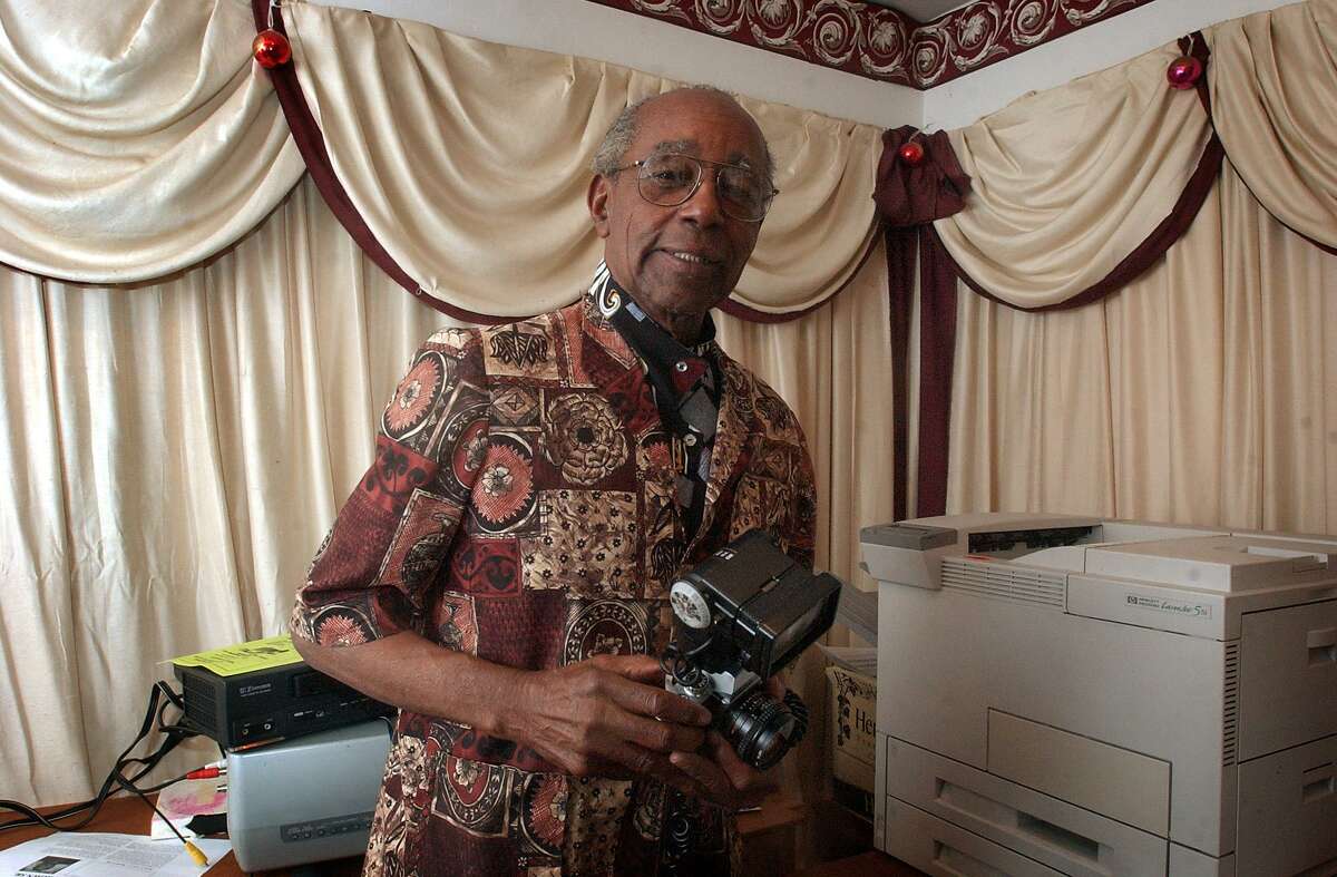 Eugene Coleman, longtime editor of the weekly SNAP, chats with visitors in January 2004. SNAP has been covering the African-American community in San Antonio since the 1940s.