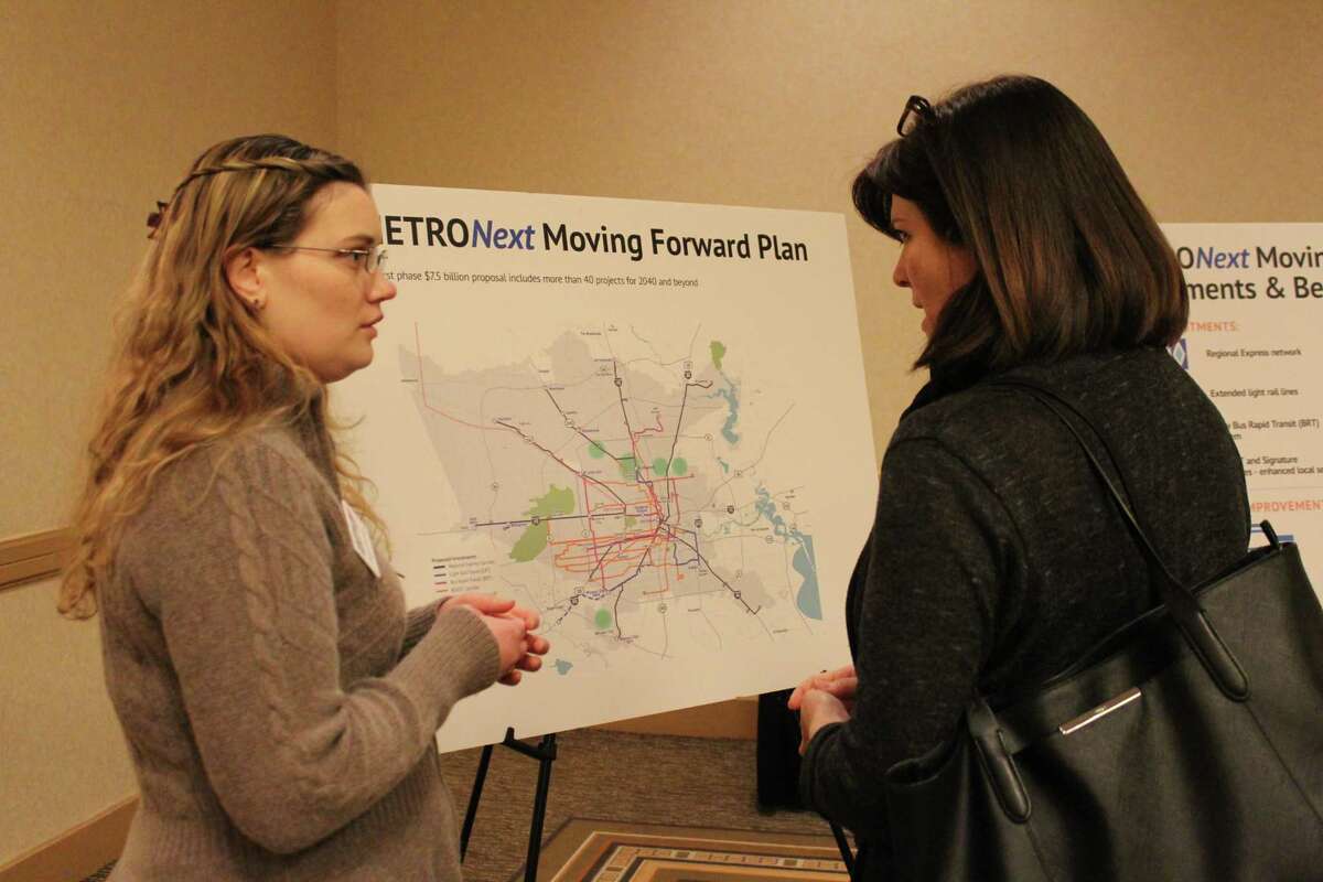 Transit System Planner Megan Kennison (left) explains to Michelle Gray the various transit improvements Metro has planned for the next 20 years.