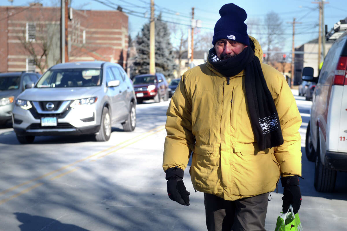 Afiran Espinet, of Bridgeport, braves the frigid cold temperatures as he walks home along Mill Hill Ave. after shopping for groceries in Bridgeport, Conn. Jan. 31, 2019.