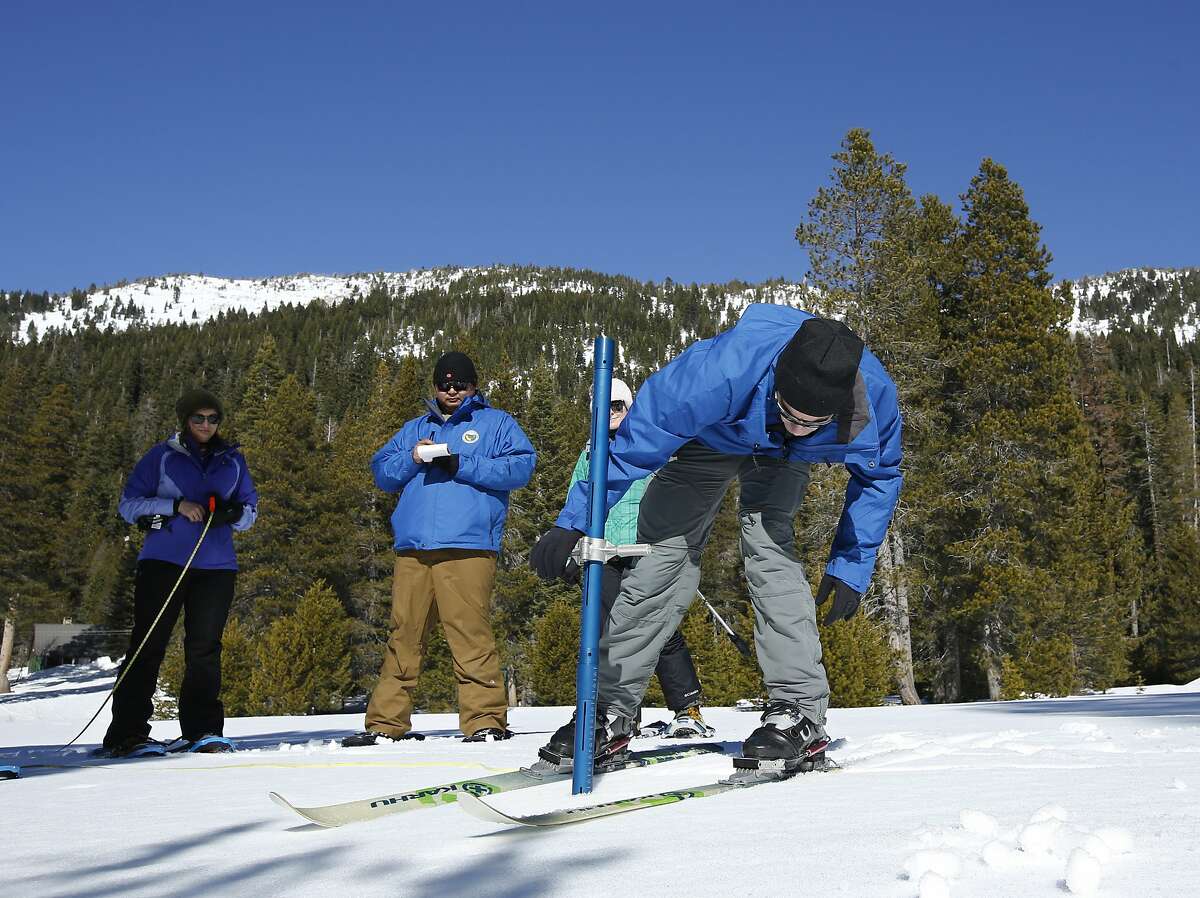 John King, of the Department of Water Resources, right, checks the snowpack depth during the second manual snow survey of the season at the Phillips station Thursday, Jan. 31, 2019, near Echo Summit, Calif. The survey shows the snow pack at 50 inches deep, with a water content of 18 inches which is 71 percent of average for this location at this time of the year. Statewide the Sierra snowpack is 98 percent of average. (AP Photo/Rich Pedroncelli)
