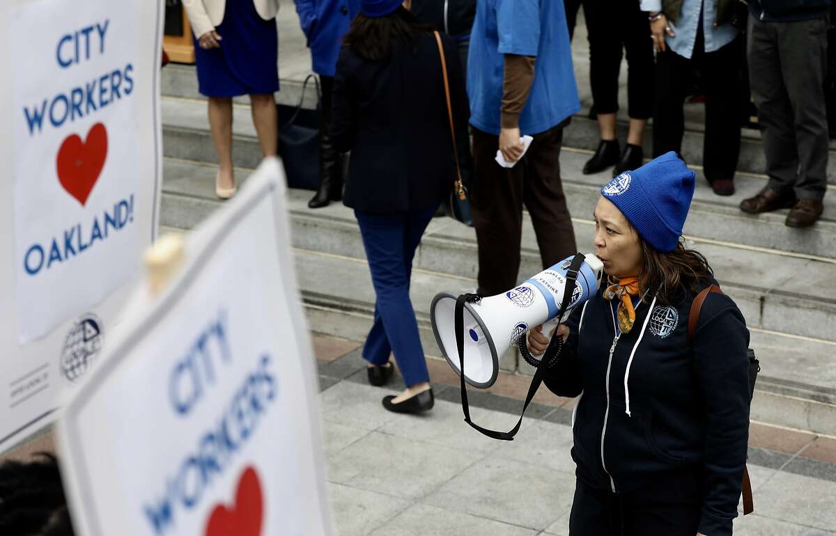 Vivian Araullo of Local 21 uses a bullhorn to say chants during an event where hundreds of City workers, elected officials, and community leaders rallied on the steps of Oakland City Hall to demand action on a rising staff vacancy rate in city agencies, and retention of city staff in the face of public service wage levels that lag neighboring jurisdictions by as much as 10% in Oakland, Calif., on Thursday, January 31, 2019.