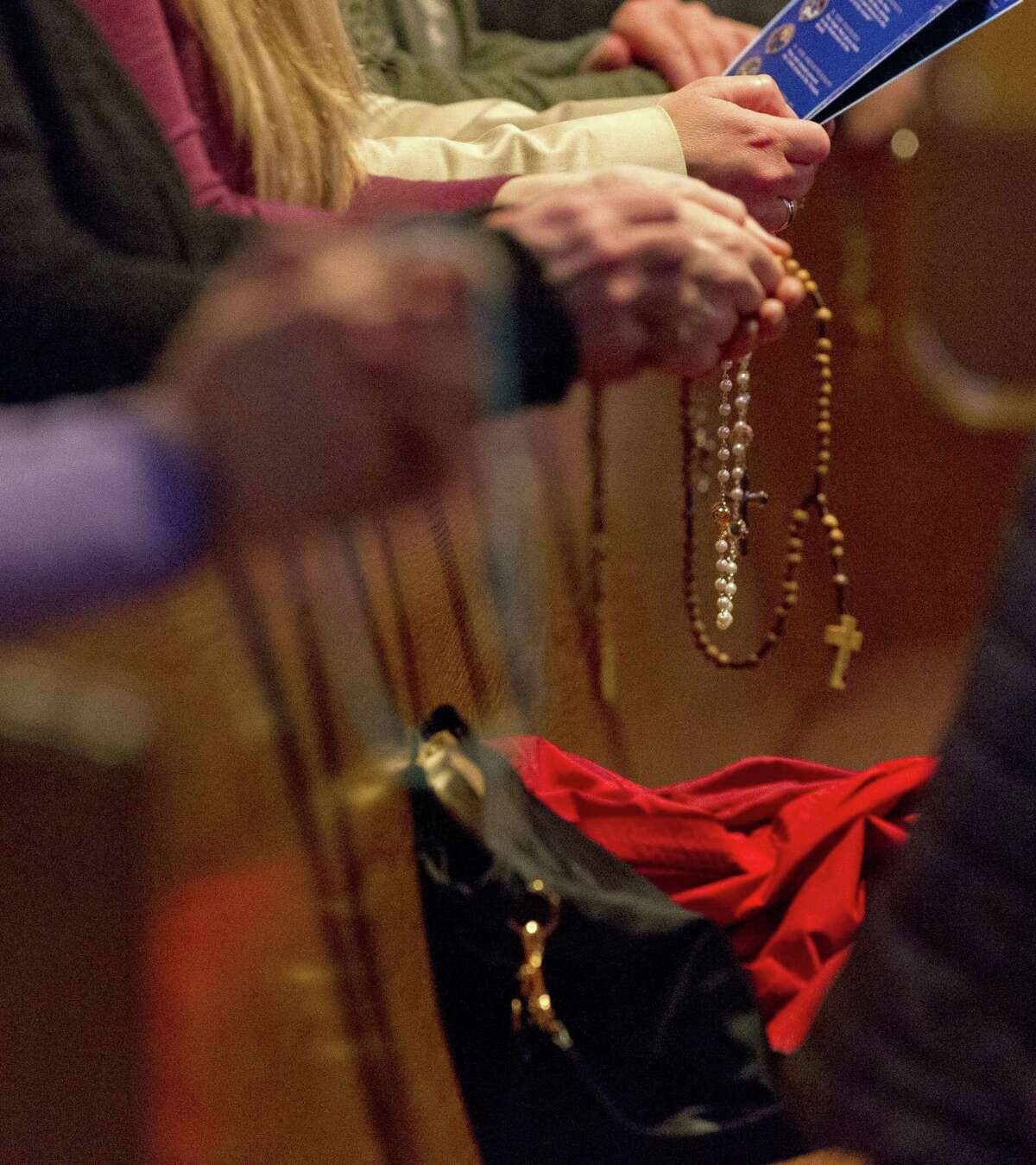 Worshipers hold rosaries as they pray at St. Anthony of Padua Catholic Church, Thursday, Jan 31, 2019, in The Woodlands. The Archdiocese of Galveston-Houston released names of more than 40 priests, clergy and staff 'credibly' accused of sexual abuse or misconduct with a minor since 1950.