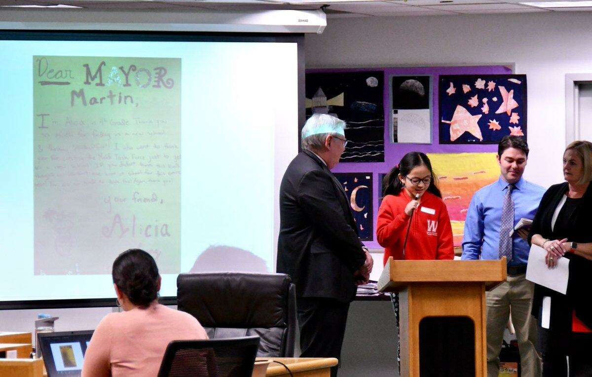 Alicia, a fourth grader from Westover Magnet Elementary School, reads a thank you note to Mayor David Martin at a Board of Education meeting in Stamford, Conn. on Jan. 29, 2019. Westover students presented at the meeting to thank public officials for placing them in a new school building after their old one closed due to mold infestation.