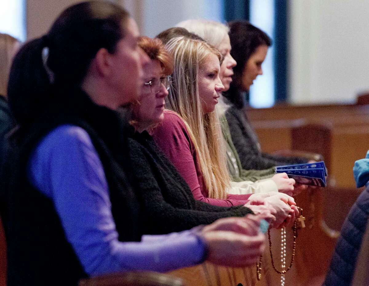 Worshipers hold rosaries as they pray at St. Anthony of Padua Catholic Church, Thursday, Jan 31, 2019, in The Woodlands. The Archdiocese of Galveston-Houston released names of more than 40 priests, clergy and staff 'credibly' accused of sexual abuse or misconduct with a minor since 1950.