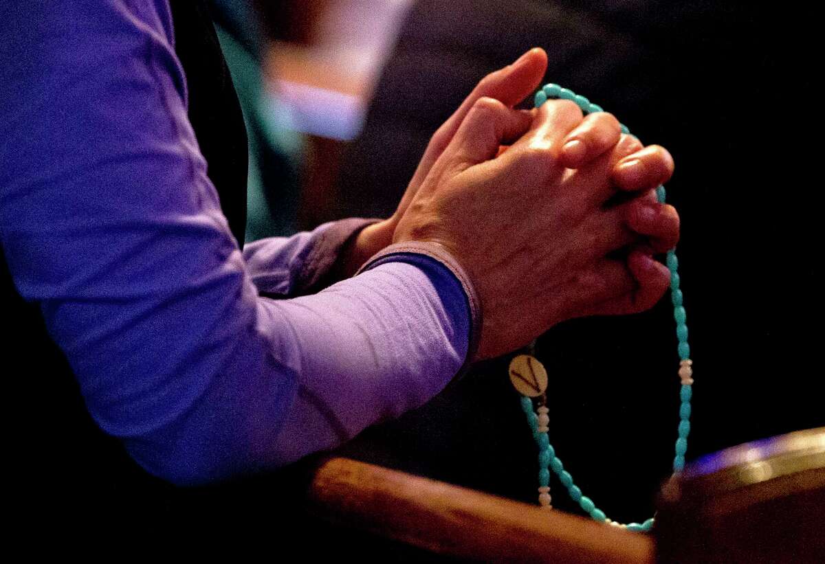 A woman holds a rosary at St. Anthony of Padua Catholic Church, Thursday, Jan 31, 2019, in The Woodlands. The Archdiocese of Galveston-Houston released names of more than 40 priests, clergy and staff 'credibly' accused of sexual abuse or misconduct with a minor since 1950.