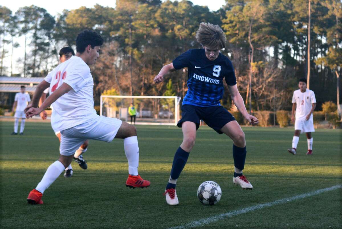 Kingwood junior forward William Tucker, right, works the ball against Westfield freshman midfielder Justino Guerrero, left, during their match at the Kilt Cup in The Woodlands on Jan. 5, 2019.