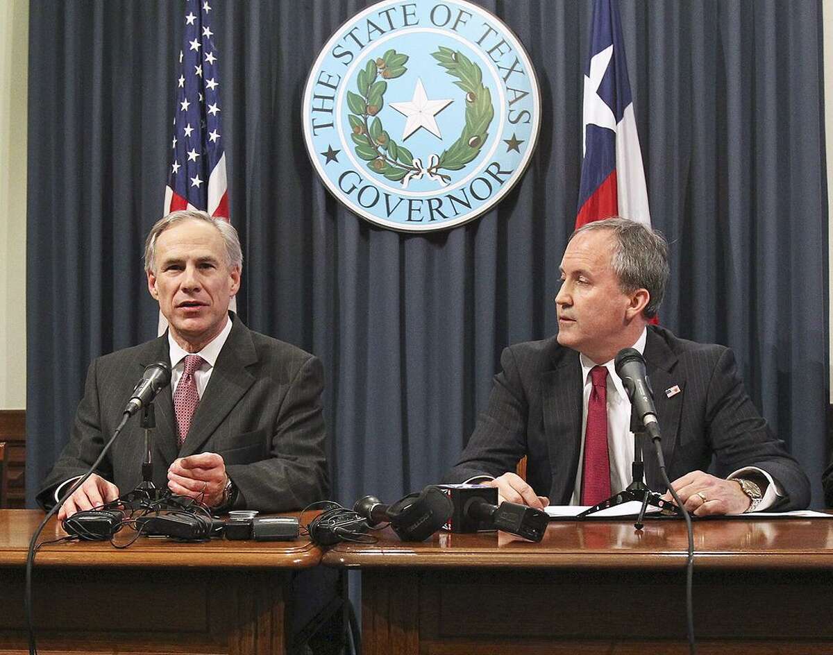 Governor Greg Abbott is joined by Attorney General Ken Paxton at a press conference in February, 2015.