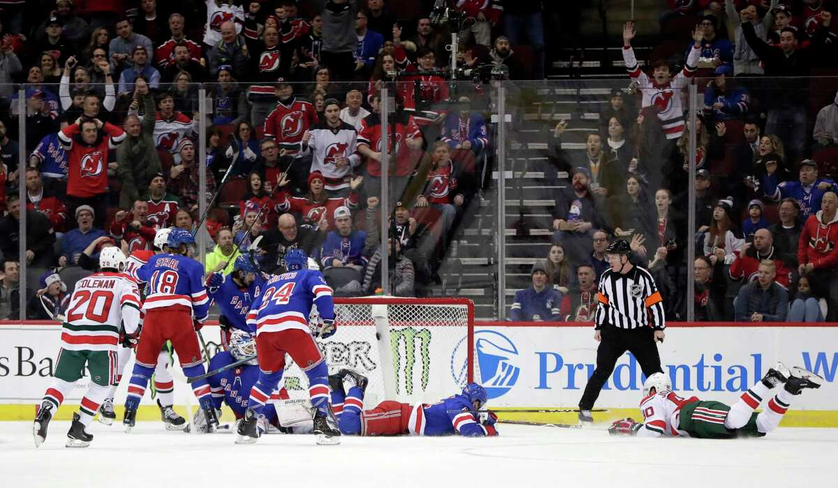 New Jersey Devils left wing Marcus Johansson, right, of Sweden, falls forward while scoring a goal on the New York Rangers during the first period of an NHL hockey game, Thursday, Jan. 31, 2019, in Newark, N.J. (AP Photo/Julio Cortez)