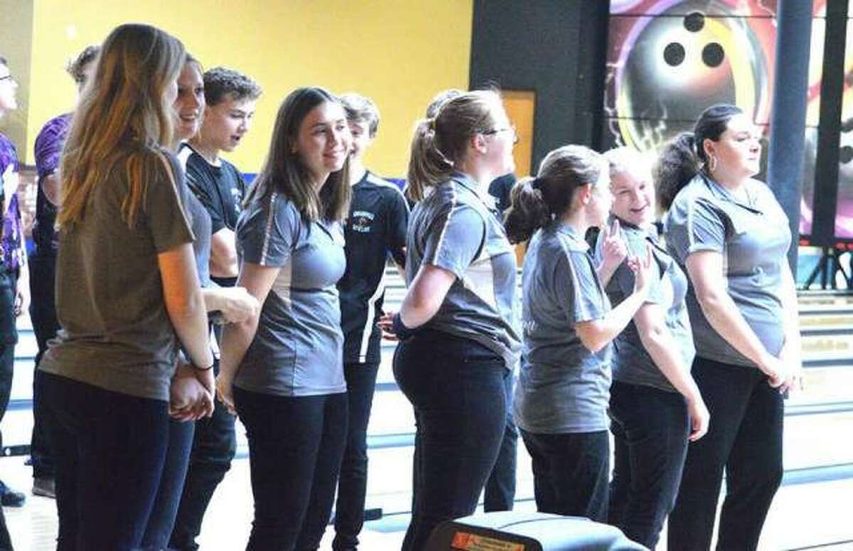 The Edwardsville girls’ bowling team lines up for the national anthem prior to a Southwestern Conference dual match against Collinsville on Jan. 8 at Edison’s Entertainment Center.