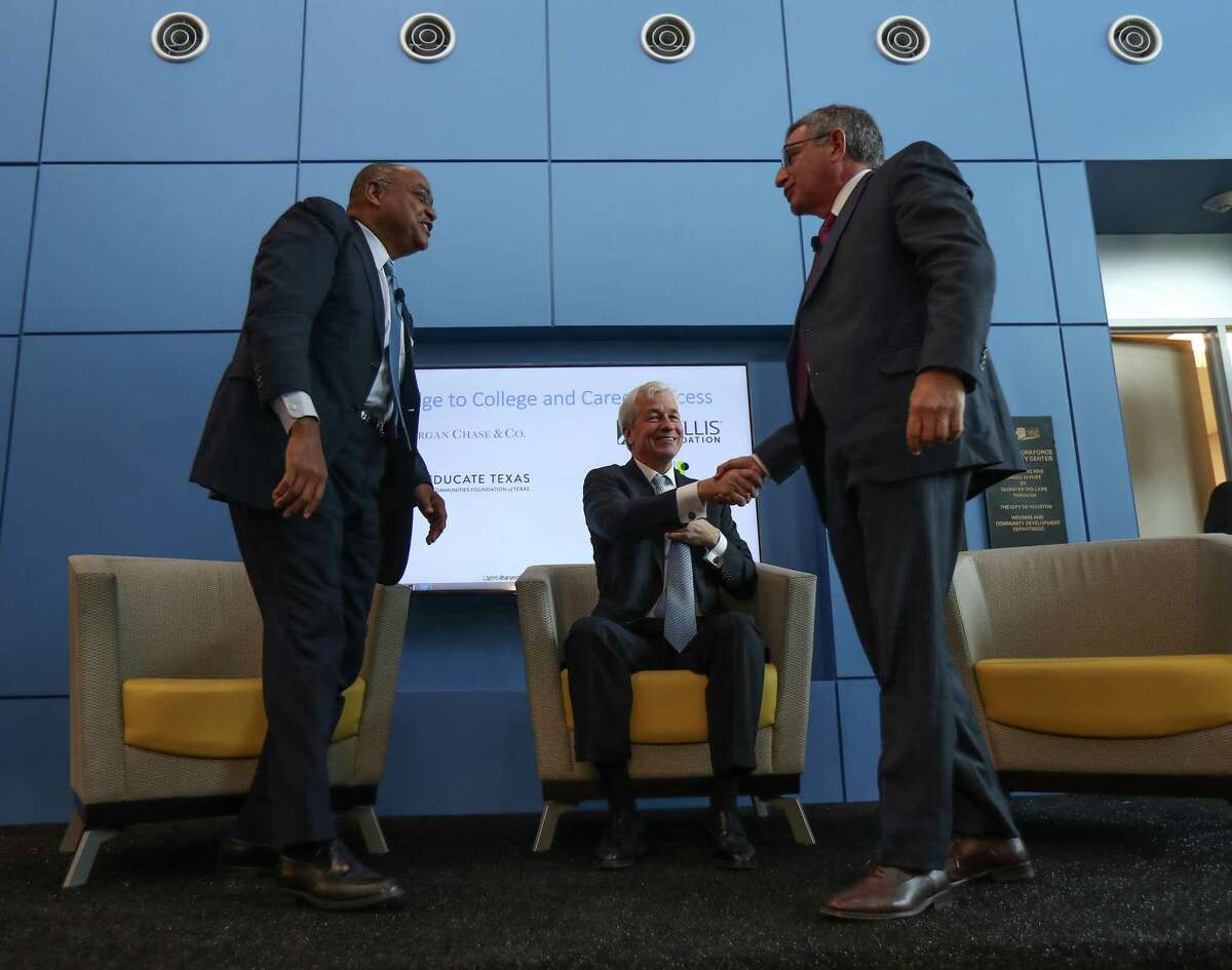 Harris County Commissioner for Precinct One Rodney Ellis, left, Chase Bank CEO Jamie Dimon, center, and Baylor College of Medicine Dr. Paul Klotman talk during a Jan. 31, 2019, event at SER Jobs where Chase is donating $1.3 million to help disconnected youths.