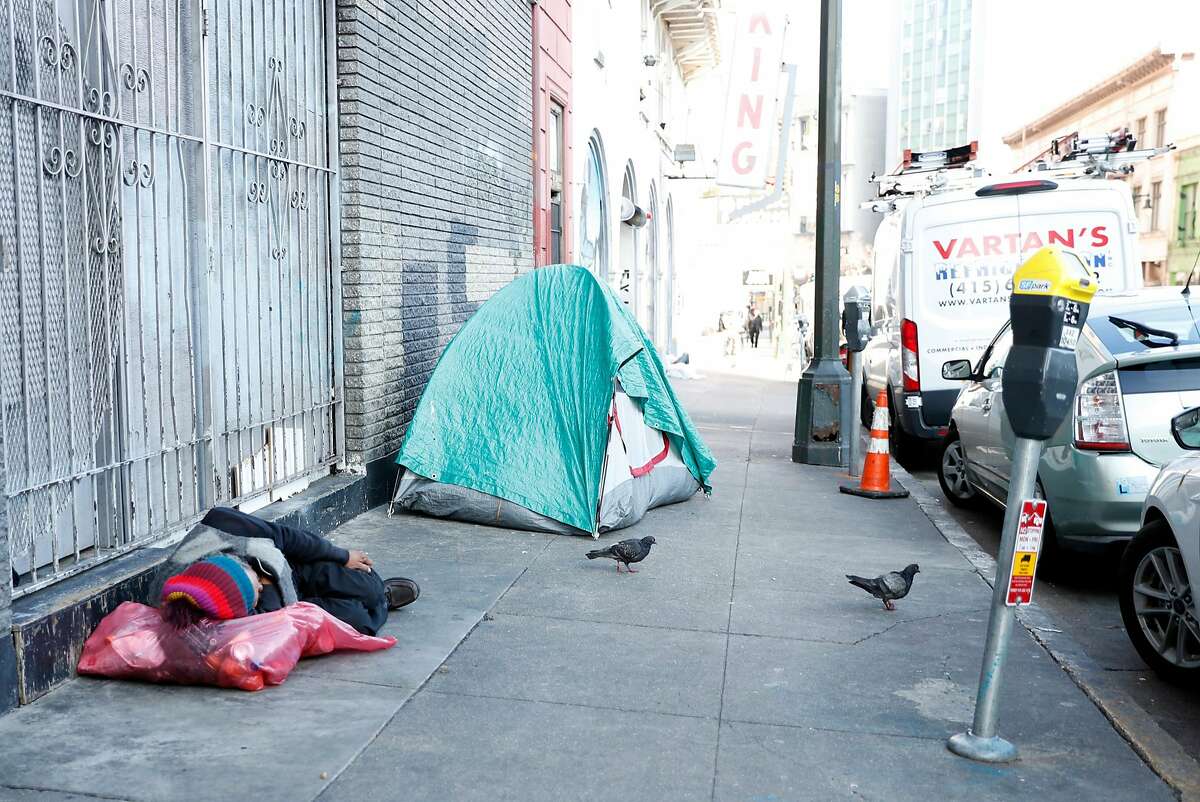A man sleeps on a Golden Gate Avenue sidewalk in San Francisco, Calif., on Thursday, January 31, 2019.