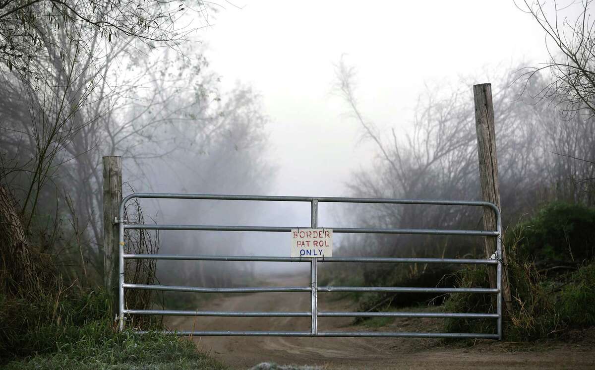 A gate to a ranch road is seen in the early morning fog along the Rio Grande near San Ygnacio.