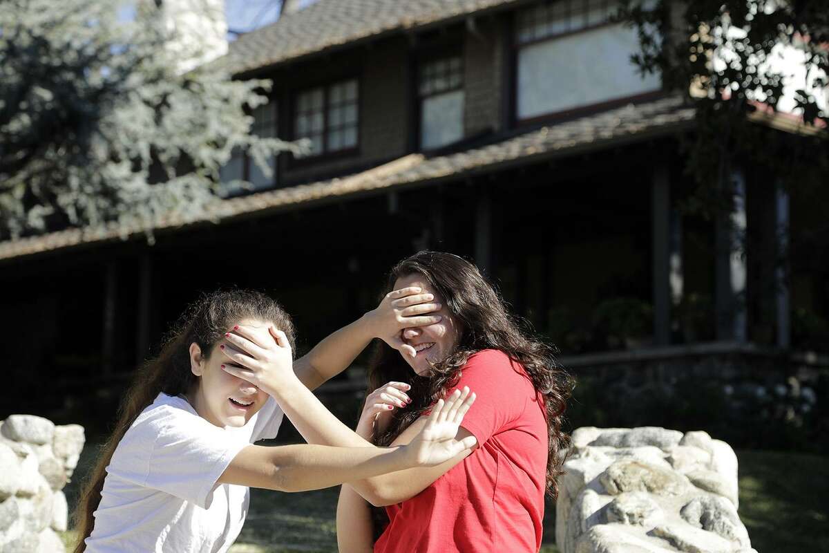 Abby Olague, 15, left, and her sister Bella Olague, 14, of Chino, Calif. improvise their "Bird Box" pose on Jan. 4 at the "Bird Box" house in Monrovia, Calif. A reader advises those who are curious to know what it is really like to be blind to view the “My Heart is Not Blind” exhibit at the Witte Museum.
