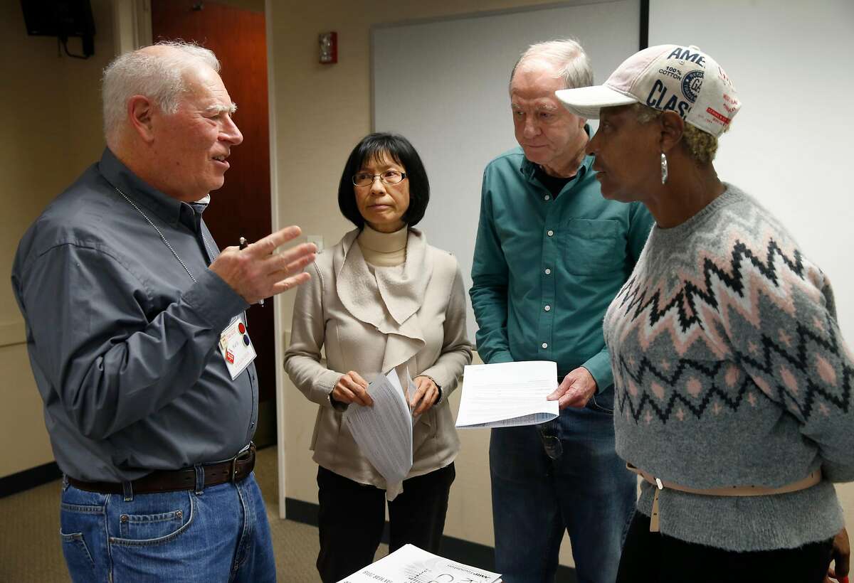 Hal Helfand (left) answers questions from tax preparers, who will be volunteering their services for the AARP Foundation Tax-Aide program, during a two-day training session in Oakland, Calif. on Wednesday, Jan. 23, 2019.
