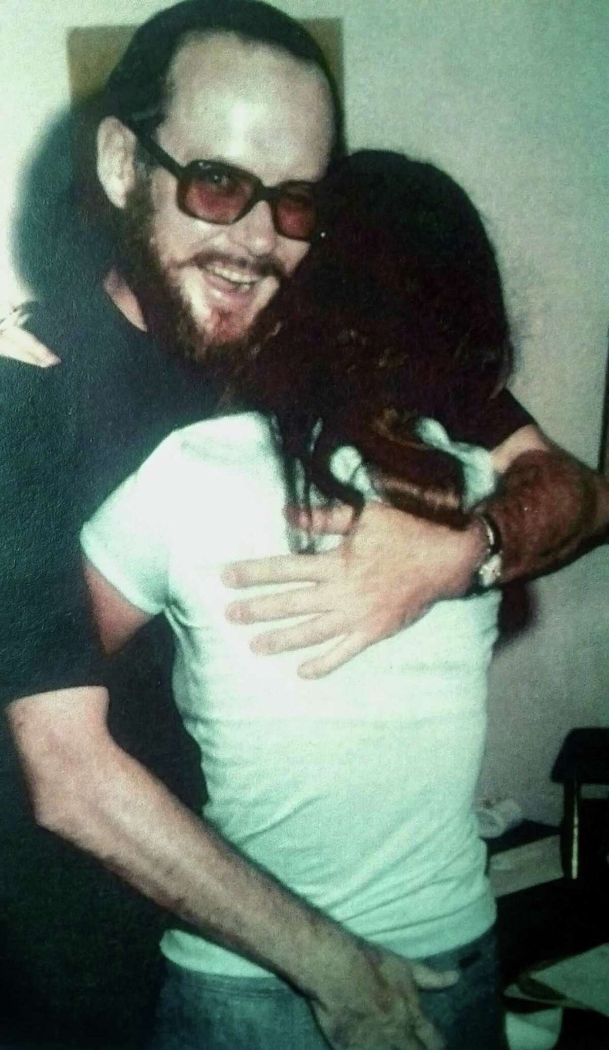 Father Charles H. Miller, identified in the Archdiocese of San Antonio's report on priests credibly accused of sexual abuse of minors, is shown in a photo taken around 1977 in St. Louis, Missouri, embracing a 14-year-old girl at a social event. She later told his Marianist order that he molested her at least twice in San Antonio when she was 17 and he was a theology professor at St. Mary's University. The woman, now a registered nurse in St. Louis, has asked that the Express-News not identify her.