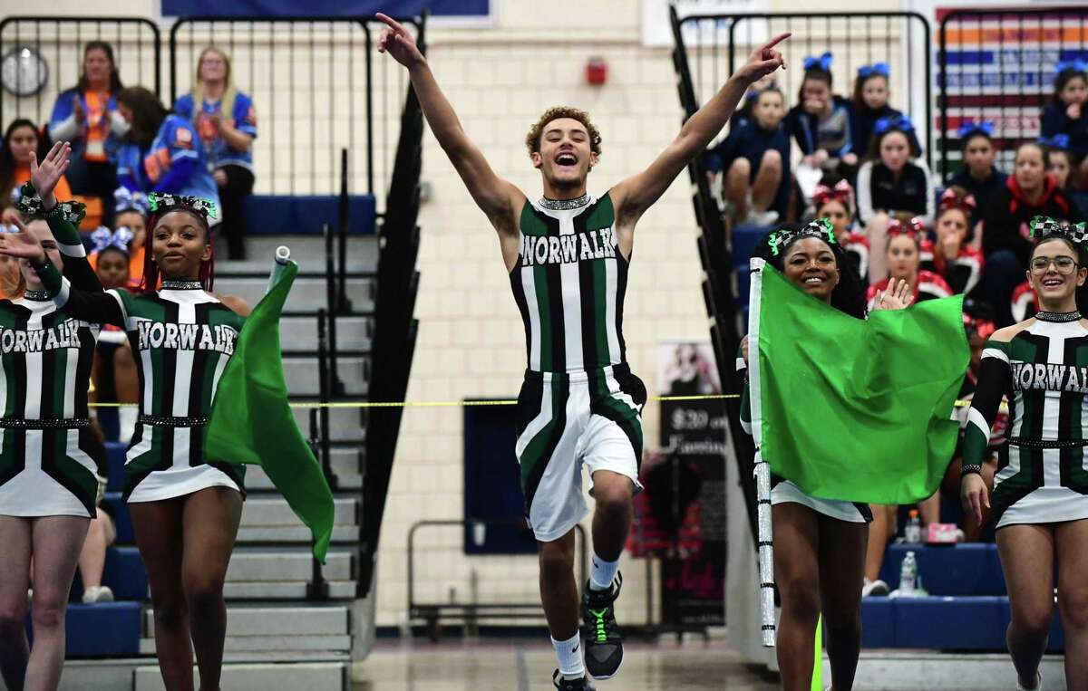 Sabastian Longo and the Norwalk High School Co-ed Varsity Cheerleading Squad competes in the 22nd annual FCIAC cheerleading championships on Saturday at Wilton High School.