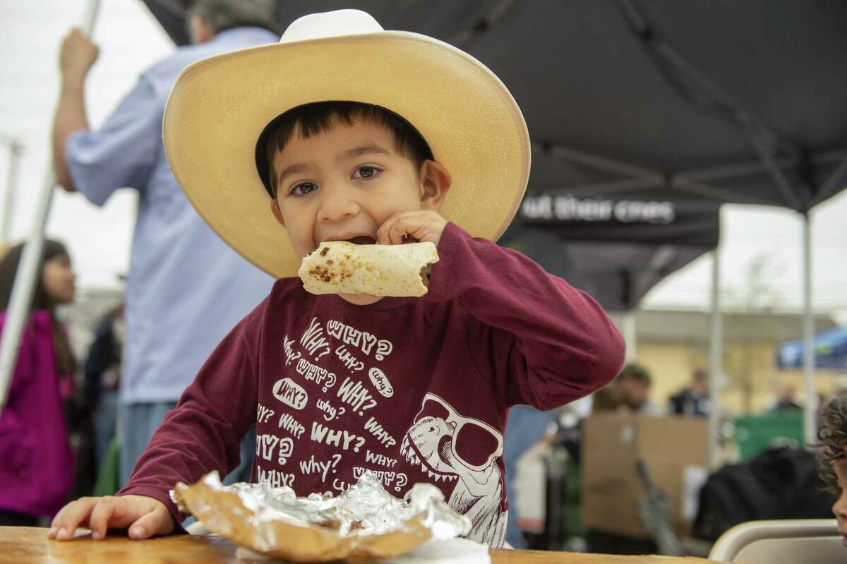 Silas Torres, 4, eats one of more than 10,000 tacos handed out Saturday, February 2, 2019 at the third annual Bexar County Rodeo Breakfast at Precinct 1 County Commissioner Rodriguez's office. The event is a counterpart to the better-known Cowboy Breakfast that kicks off the San Antonio Stock Show and Rodeo, but is held on the South Side and on a weekend to make it more accessible.