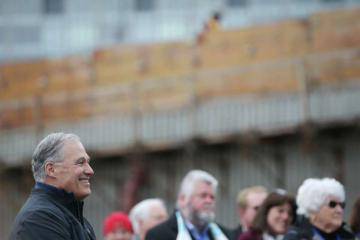 Washington Governor Jay Inslee listens during an offical ribbon cutting ceremony to celebrate the opening of the new SR 99 tunnel, which opened to drivers on Monday, Saturday, Jan. 2, 2019. (Genna Martin, SeattlePI)